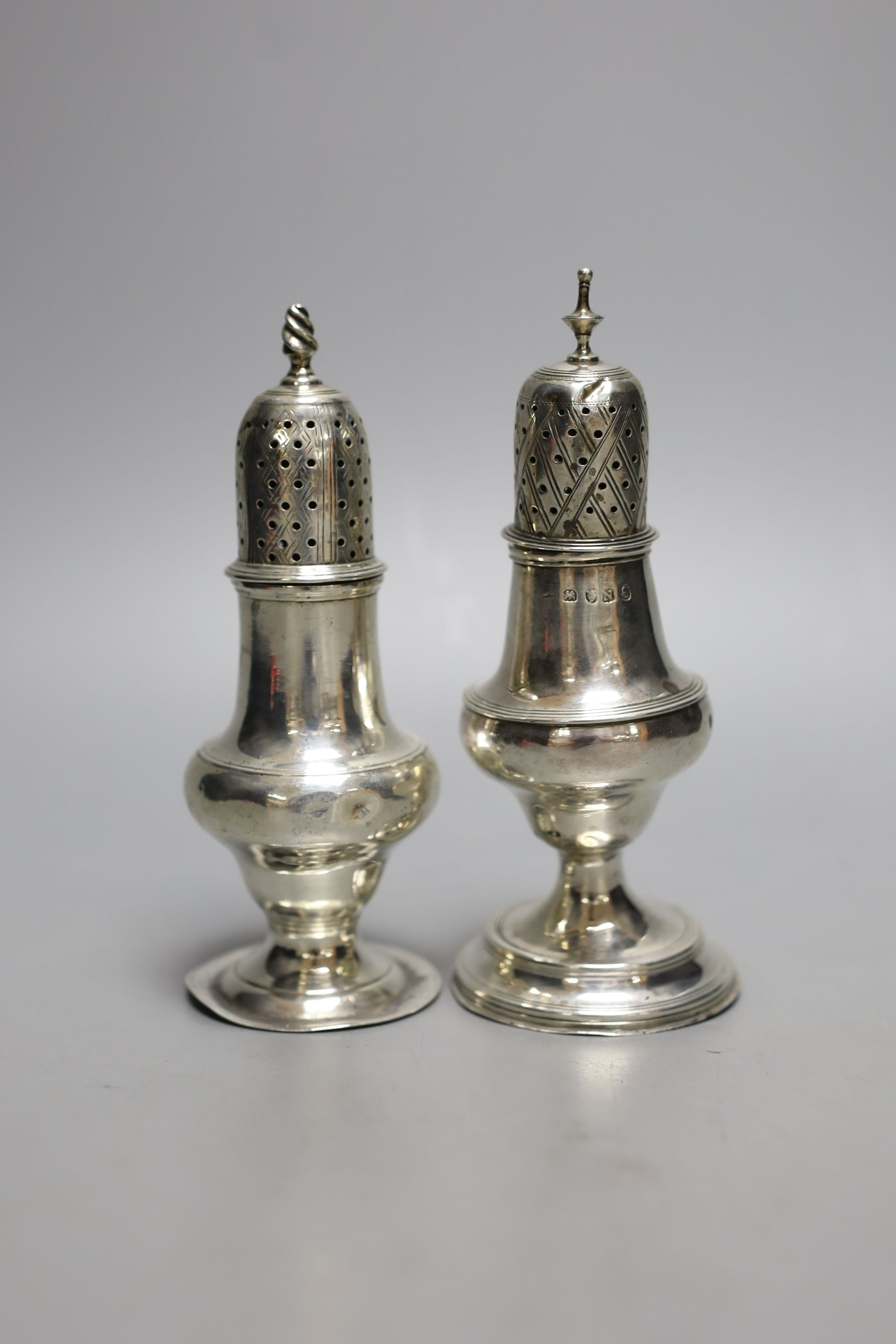 A George III silver pepperette, London, 1808, 13.9cm and one earlier silver pepperette with spiral finial, London, 1780.